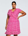 A plus size woman wearing a Estelle Grapa Floral Dress.