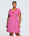 A plus size woman wearing a Estelle Grapa Floral Dress.