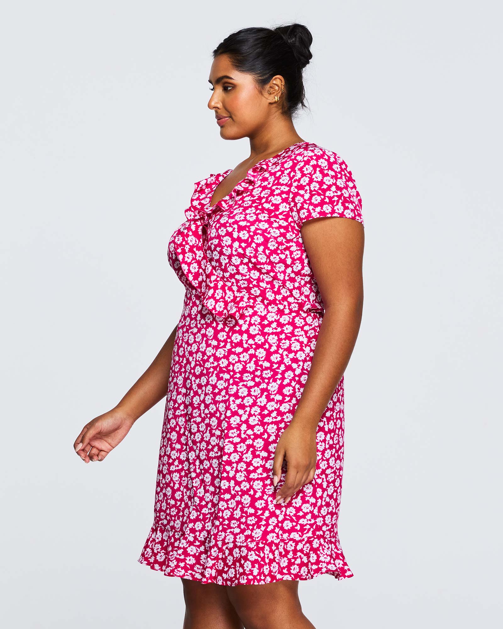 A plus size woman wearing an Estelle Grapa Floral Dress.