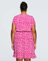 A plus size woman wearing the Estelle Grapa Floral Dress.