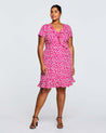 A plus size woman wearing a Estelle Grapa Floral Dress.