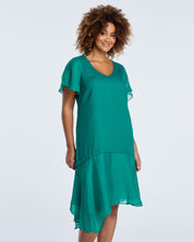 The model is wearing an Estelle Shadow Dress with asymmetric hem.
