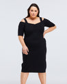 A plus size woman wearing a black Estelle Sacha Dress.