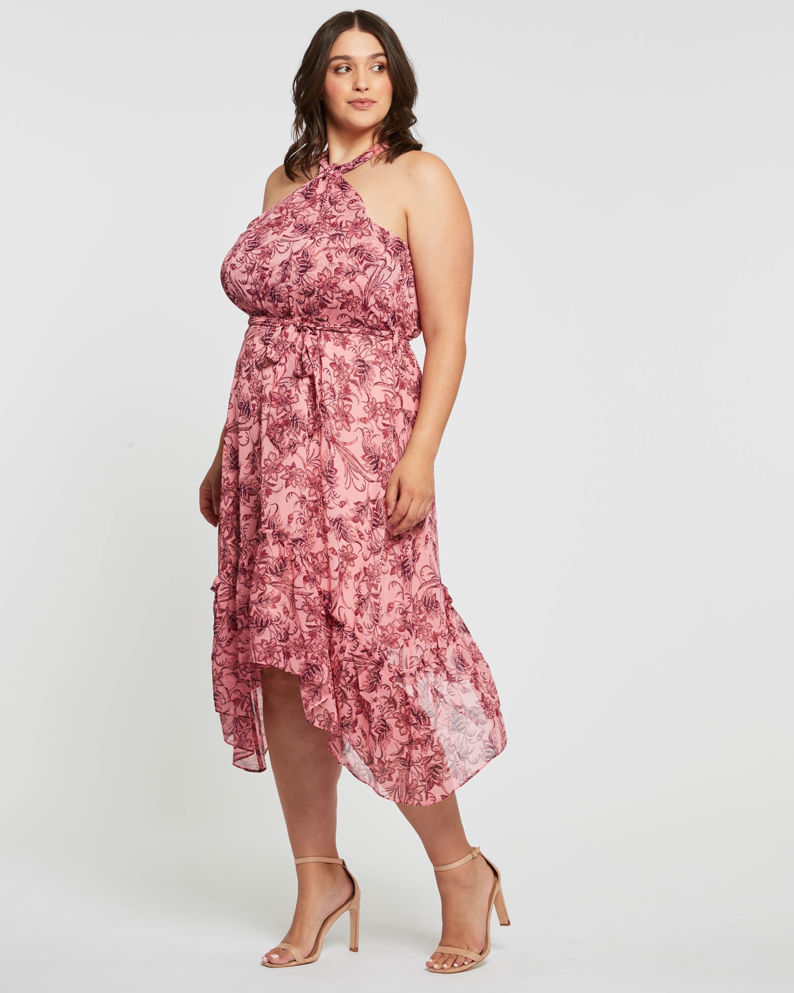 A plus size woman wearing an Estelle Sophia Halter Dress.