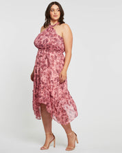 A plus size woman wearing an Estelle Sophia Halter Dress.
