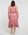 The back view of a plus size woman wearing an Estelle Sophia Halter Dress.