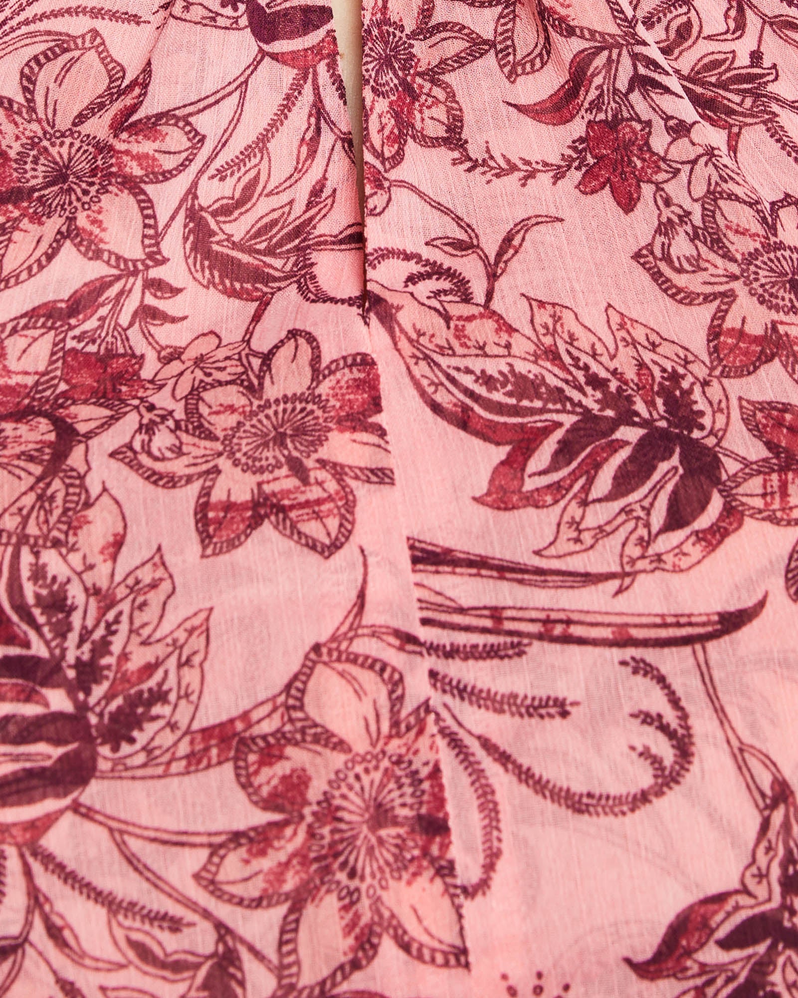 A close up of a pink floral printed Estelle Sophia Halter Dress.