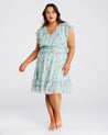 A plus size woman wearing the Estelle Green Prairie Dress.