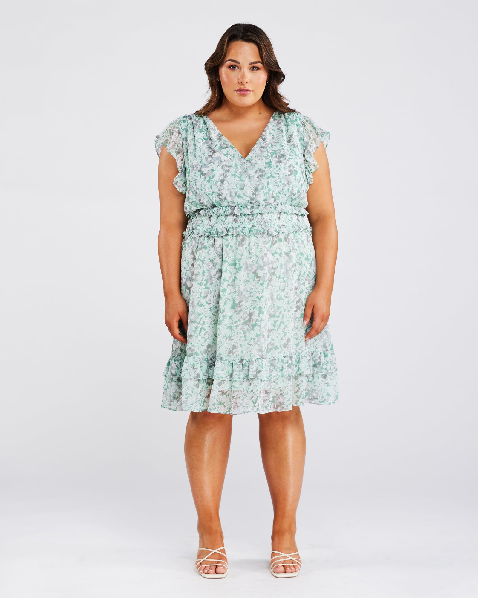 A plus size woman wearing a Estelle Green Prairie Dress.