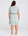 The back view of a woman wearing a Estelle Green Prairie Dress.