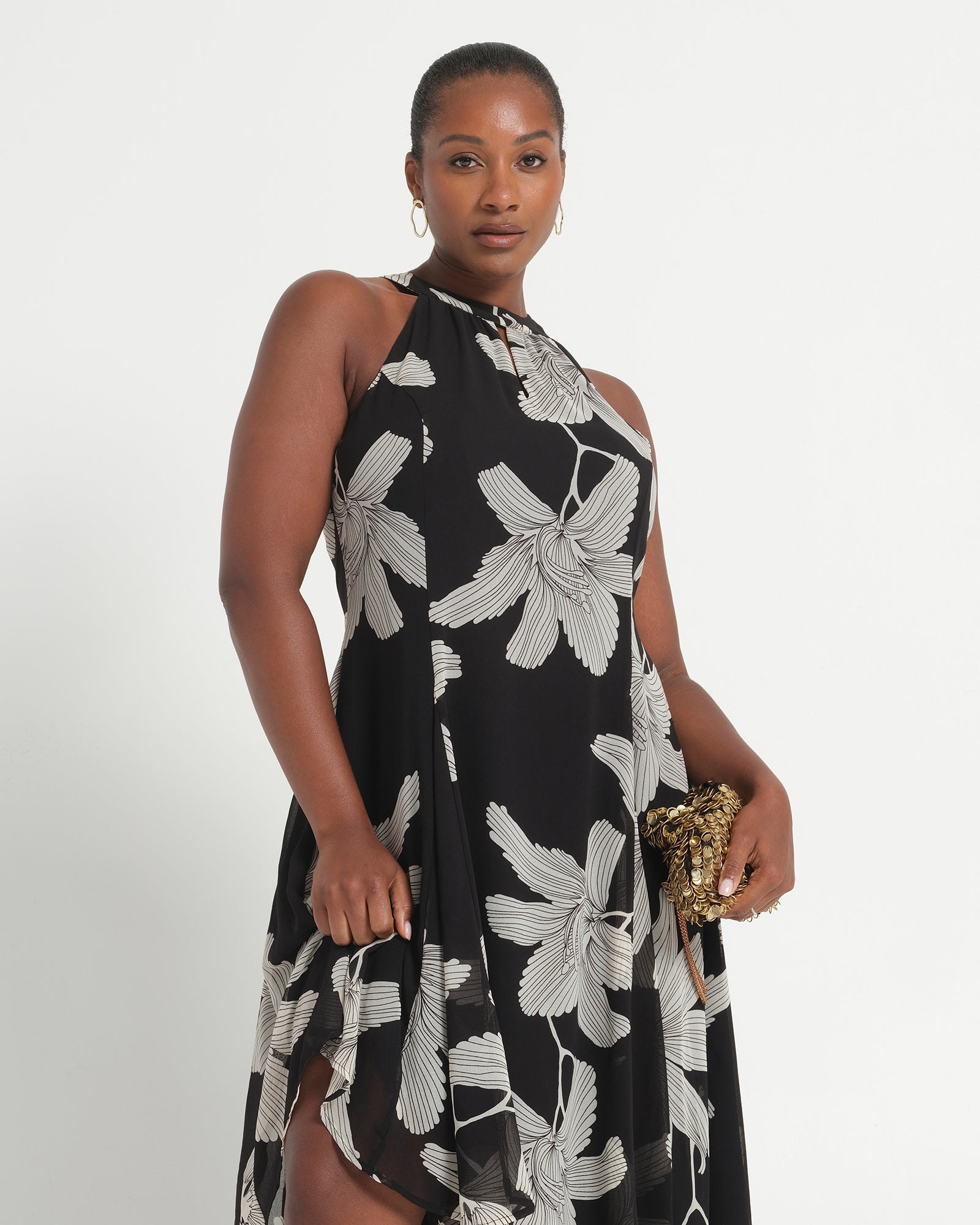 Woman wearing a black floral dress on a white background