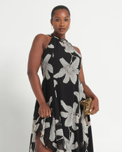 Woman wearing a black floral dress on a white background