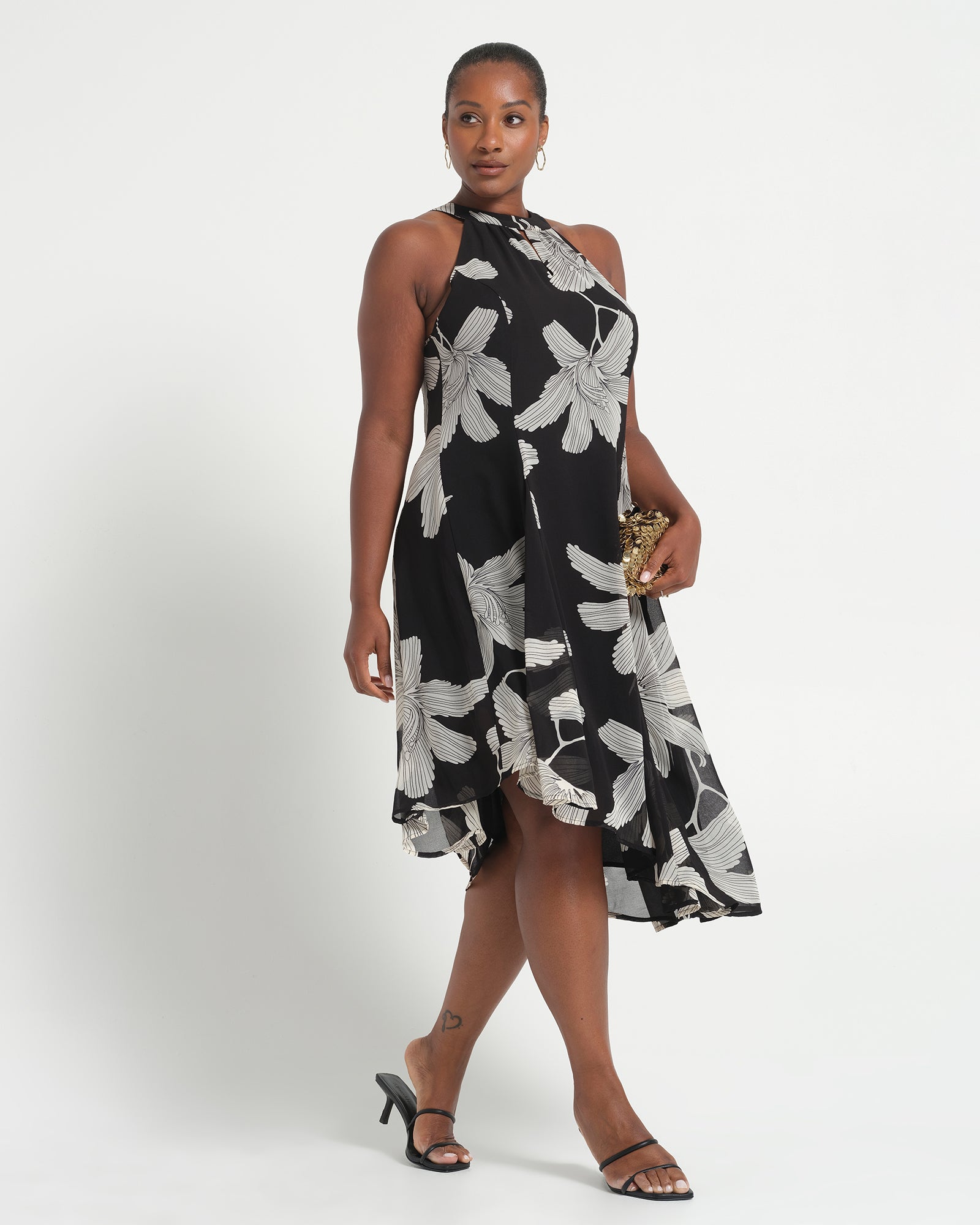 Woman wearing a black and white floral dress on a white background
