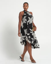 Woman wearing a black and white floral dress on a white background