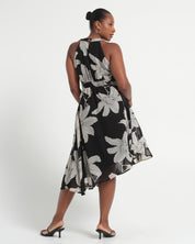 Woman wearing a black floral dress on a white background