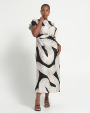 Woman wearing a black and white patterned dress on a white background