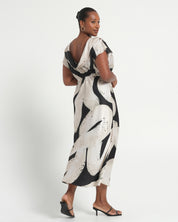 Woman wearing a black and white patterned dress on a white background