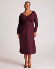 Woman wearing a burgundy dress against a white background