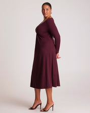 Woman wearing a burgundy dress against a white background