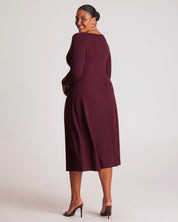 Woman wearing a burgundy dress against a white background