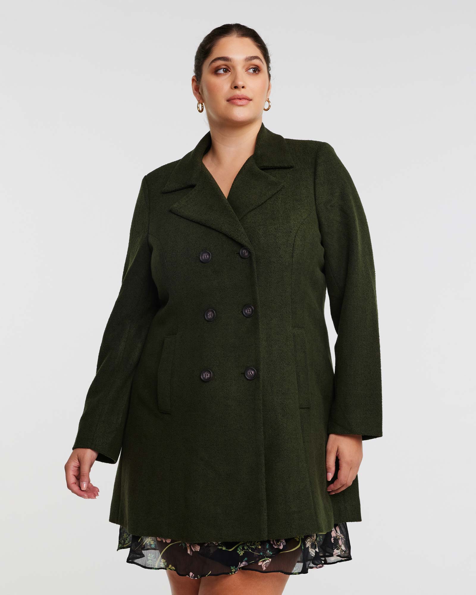 A woman is wearing a double-breasted Homeland Coat.