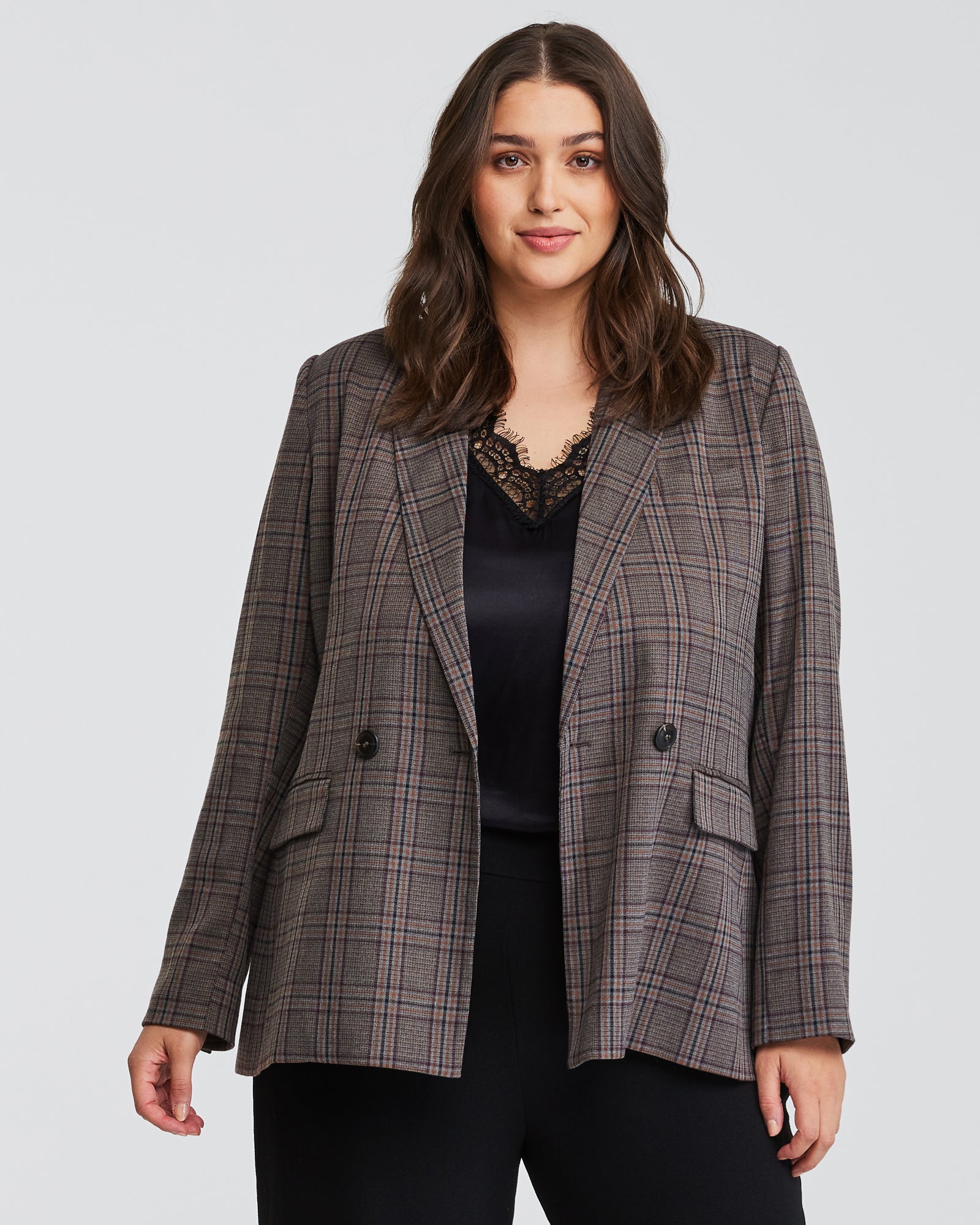 A plus-sized woman wearing a check patterned Lilibet Brown Check Double-Breasted Blazer.