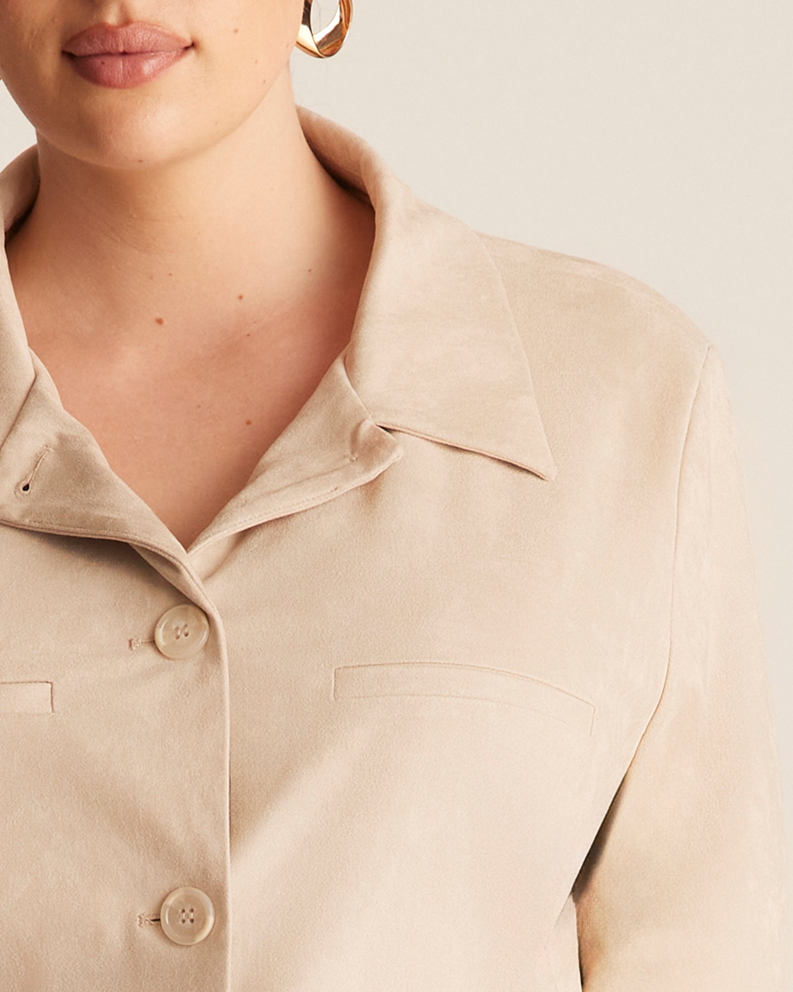 Close-up of a beige shirt with a neutral background