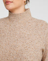 A plus-sized woman wearing a Golden Sparkle Beige/Metallic Turtle-Neck Sweater.