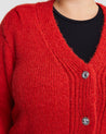 A woman wearing a cozy Embellished Cardigan with silver buttons.