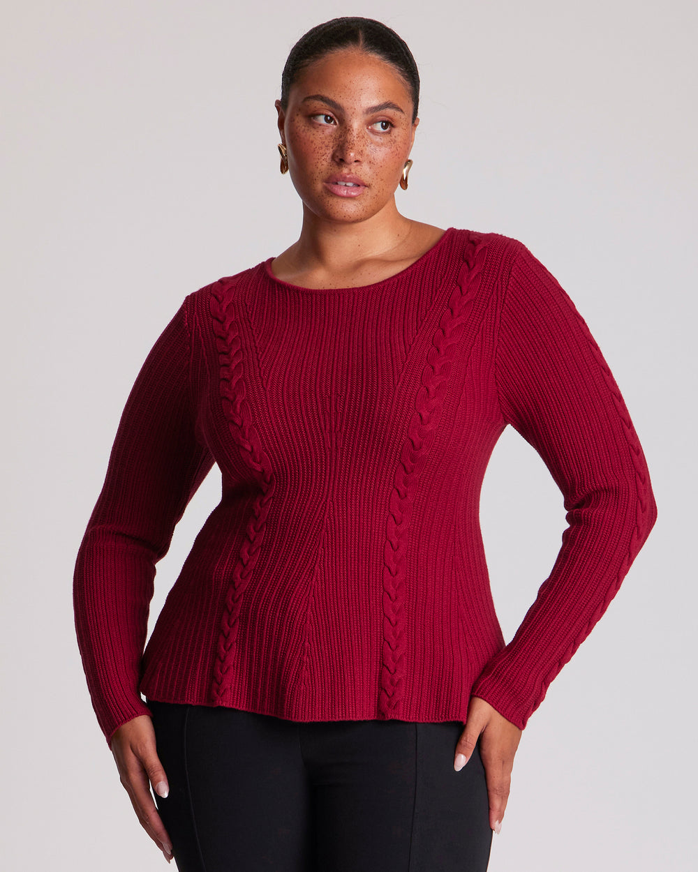 The Eveline Peplum Cable Knit Top features a classic round neckline with bind detailing and full-length sleeves for a timeless finish. Ribbed panels through the body create texture, while cable-knit detailing across the front and back adds depth and visual interest. Crafted from a soft Lyocell blend, this red cable knit top offers a distinctive silhouette with an easy slip-on design.