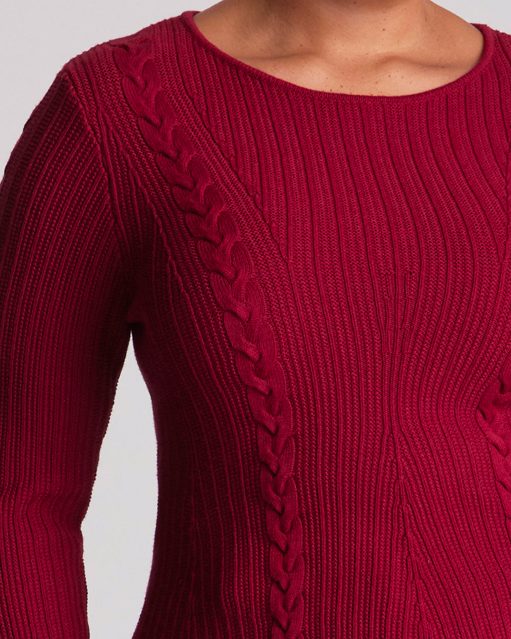The Eveline Peplum Cable Knit Top features a classic round neckline with bind detailing and full-length sleeves for a timeless finish. Ribbed panels through the body create texture, while cable-knit detailing across the front and back adds depth and visual interest. Crafted from a soft Lyocell blend, this red cable knit top offers a distinctive silhouette with an easy slip-on design.