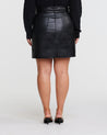 A plus-size fashionista showcasing the Black PU Vegan Leather Belted Skirt.