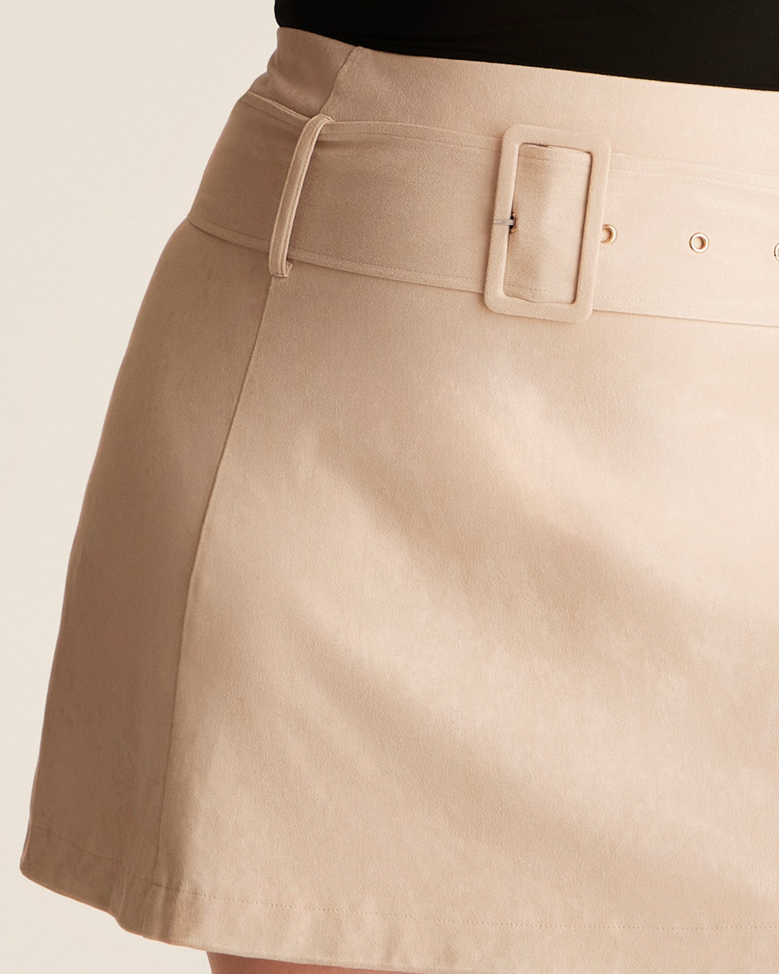 Beige skirt with a belt on a neutral background