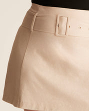 Beige skirt with a belt on a neutral background