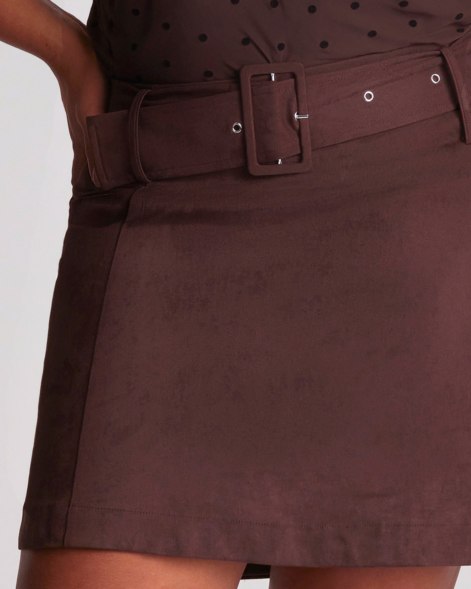 Brown skirt with a belt on a plain background