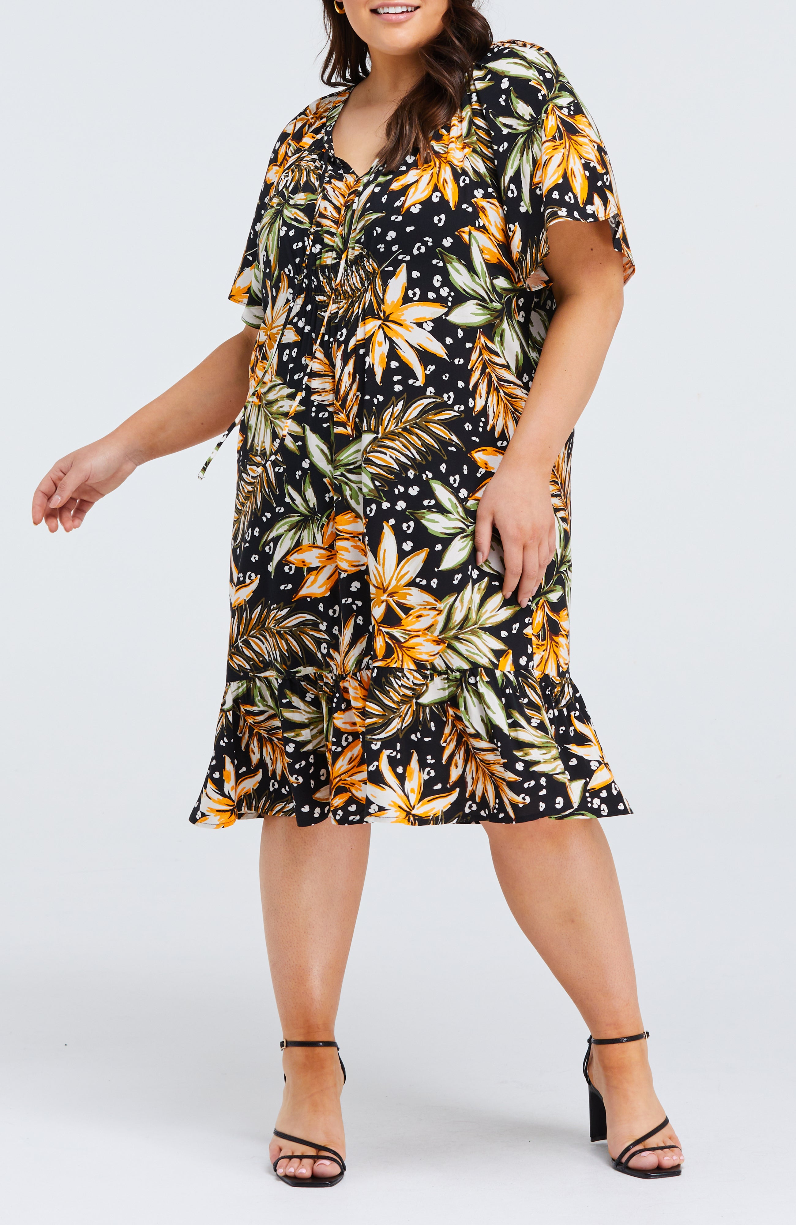 A plus size woman wearing the Estelle La Palma Dress.