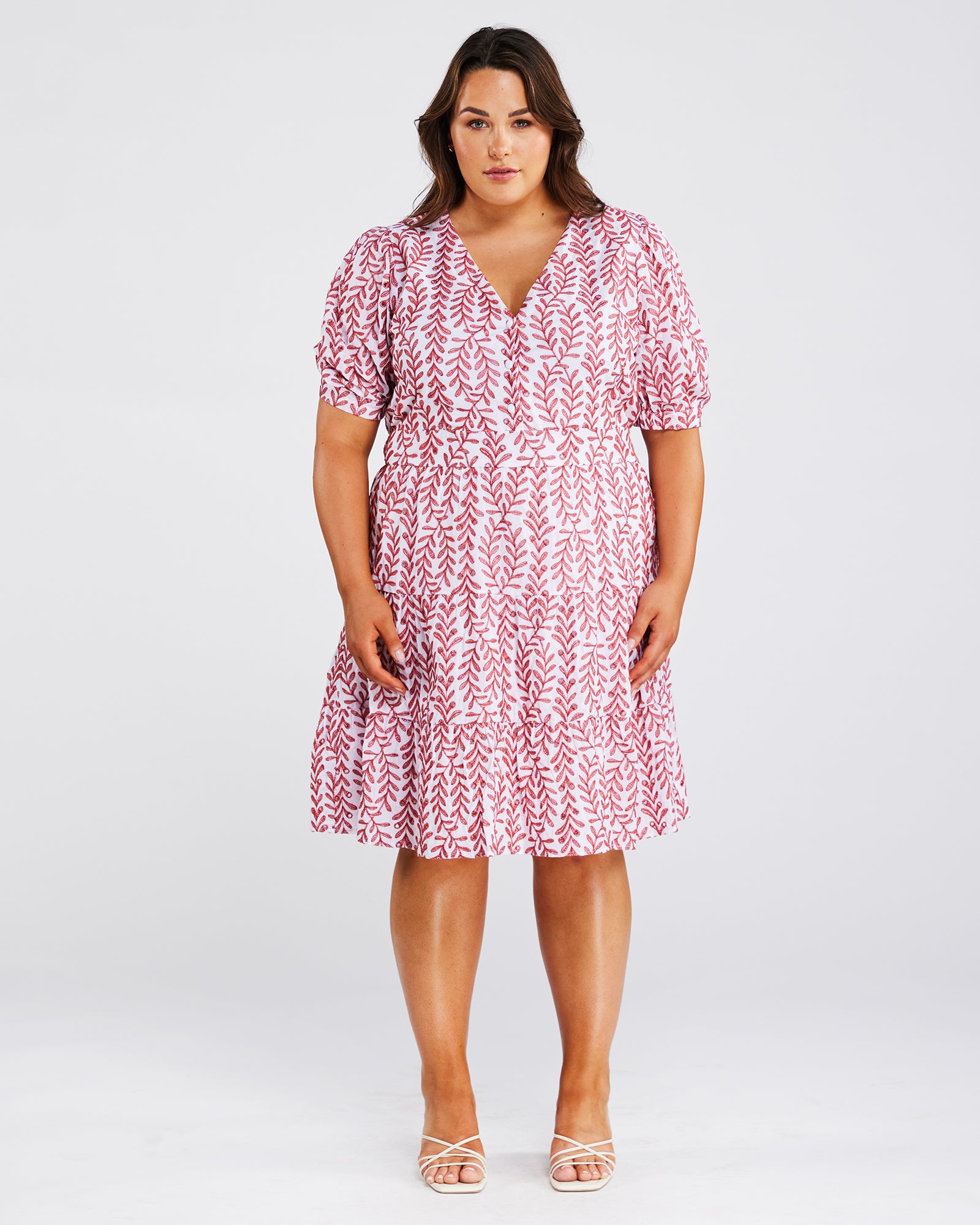 A plus size woman wearing an Estelle La Croisette Dress.