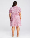 The back view of a plus size woman wearing a Estelle La Croisette Dress.