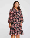 A plus size woman wearing a Woodland Floral Textured Mini Dress.