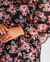 A plus-sized woman wearing a Woodland Floral Textured Mini Dress.