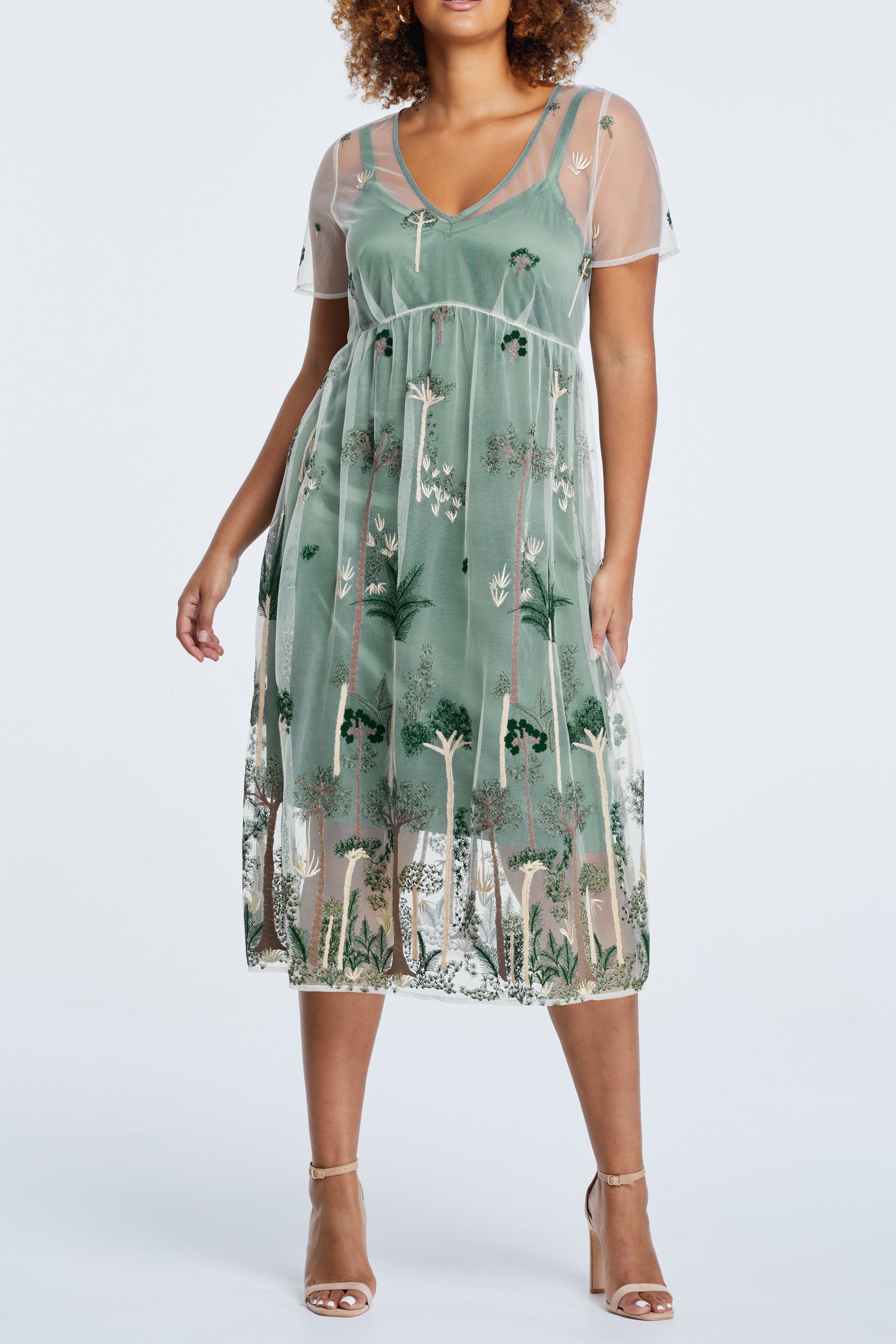 A plus size woman wearing the Estelle Leon Embroidered Mesh Dress.