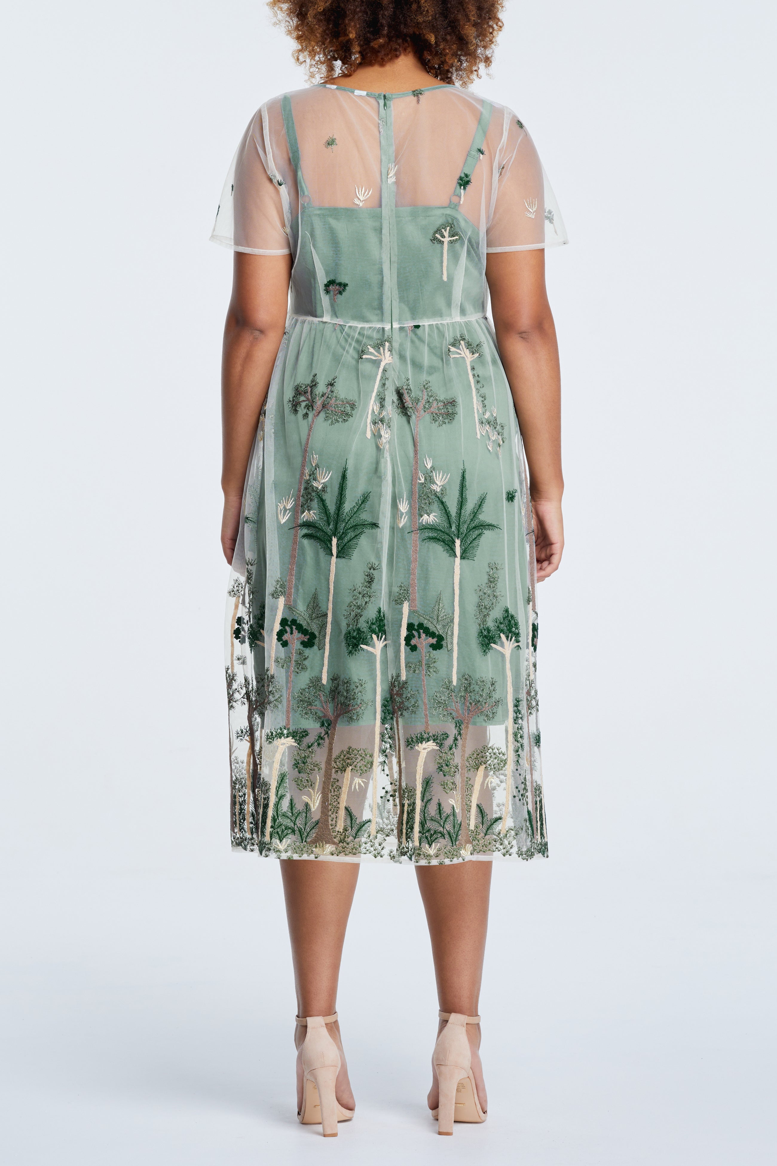 The back view of a plus size woman wearing a Estelle Leon Embroidered Mesh Dress.