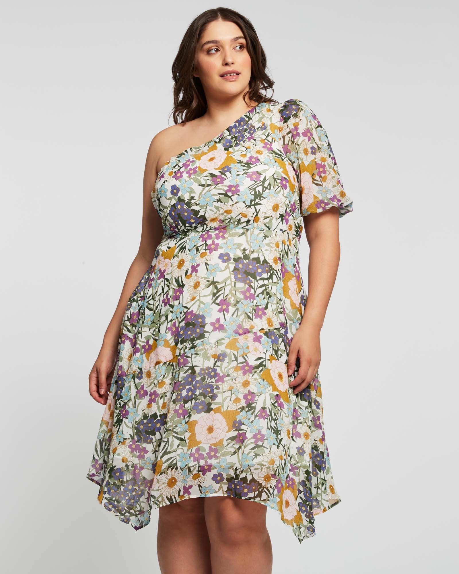 A plus size woman in the Estelle Wildbloom Midi Dress.