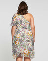 The back view of a plus size woman wearing the Estelle Wildbloom Midi Dress.