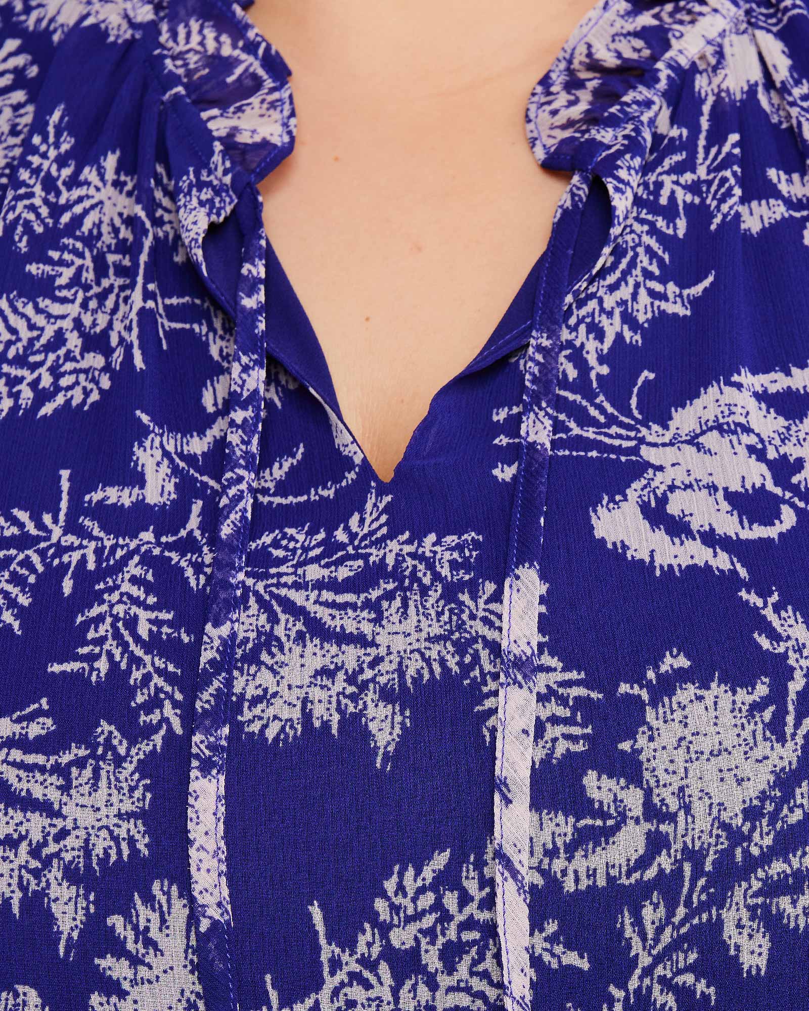 A woman wearing an Estelle Ultra Leaf Purple Tiered Knee Length Dress.