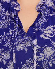 A woman wearing an Estelle Ultra Leaf Purple Tiered Knee Length Dress.