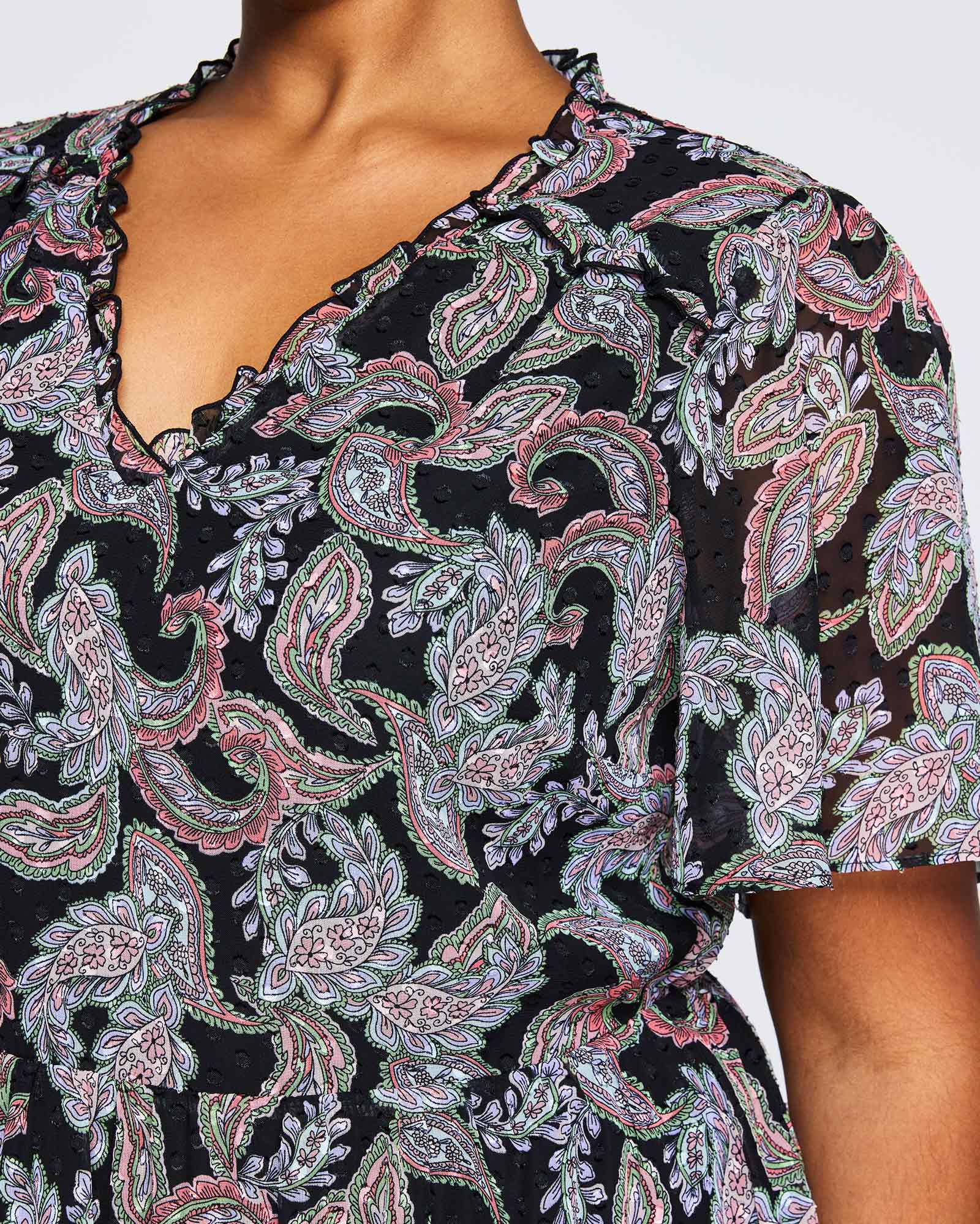 A woman wearing an Estelle Maya Purple Paisley Midi Dress.