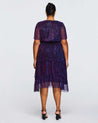 The back view of a plus size woman wearing a Glitterland Metallic Sparkly Midi Dress.