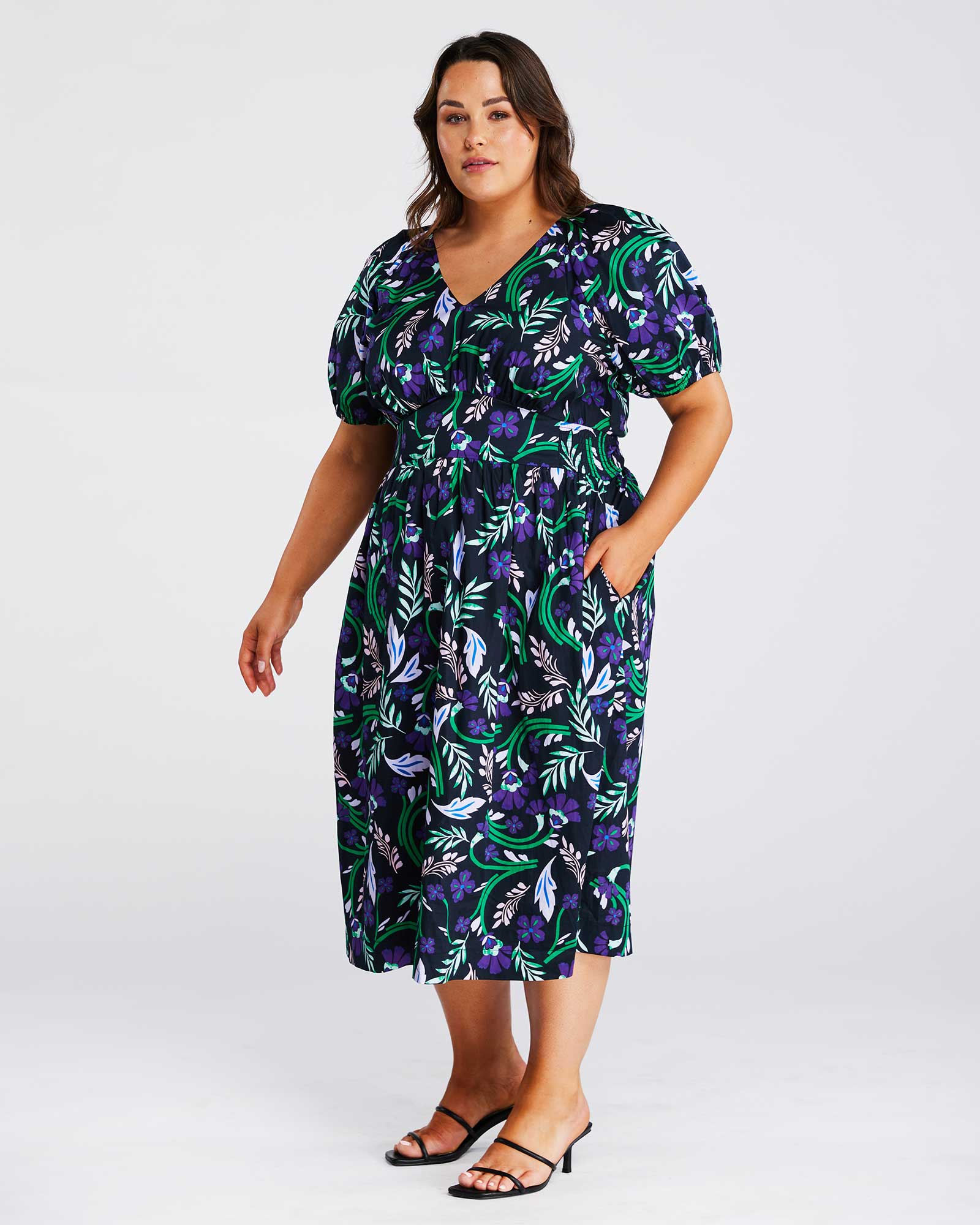 A plus-size fashionista wearing the Ultraviolet Cotton Floral Midi Dress is stunning.