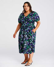 A plus-size fashionista wearing the Ultraviolet Cotton Floral Midi Dress is stunning.